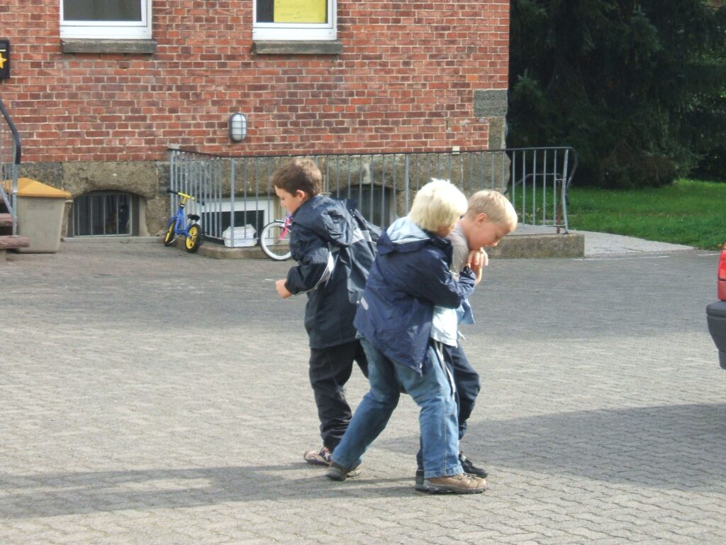 Kinder streiten sich auf dem Schulhof